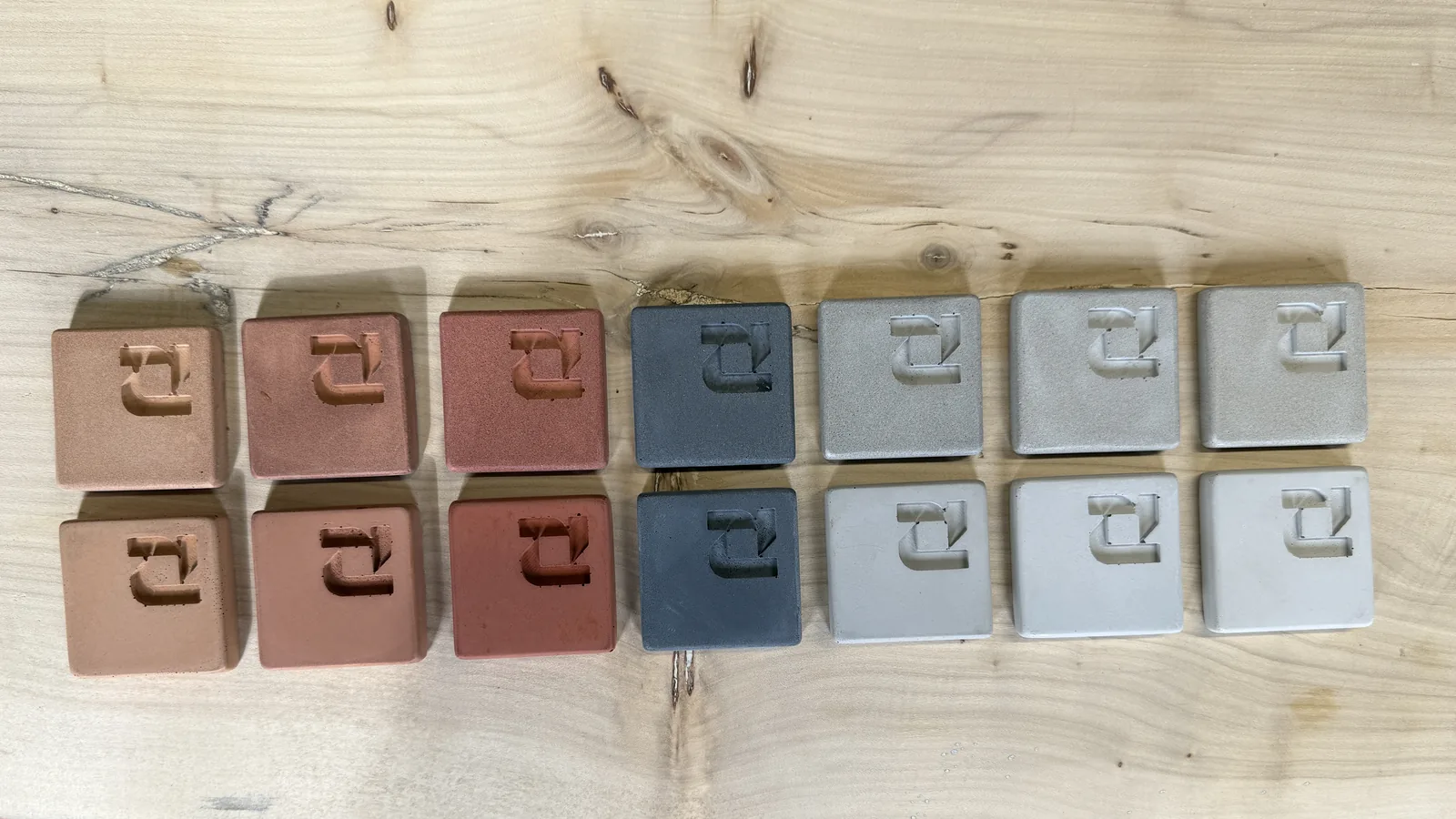 Seven ROKA concrete sample colours in pairs, salt and pepper finish on the top row and cream finish on the bottom row