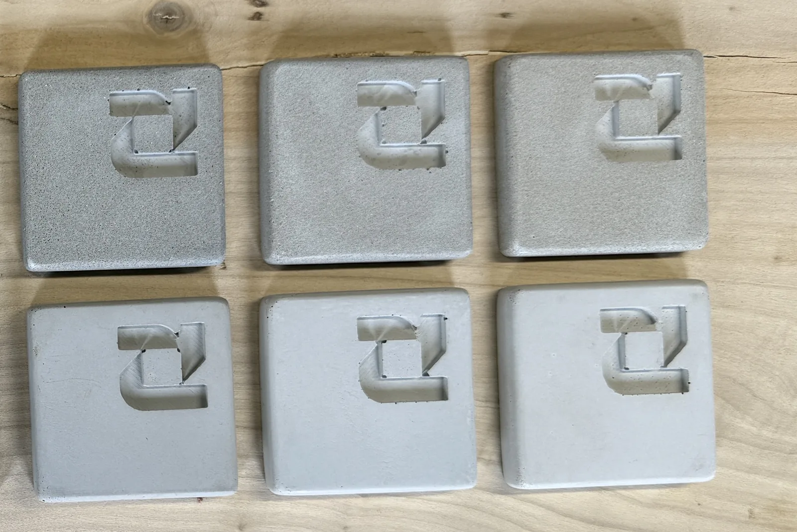 Pale grey ROKA concrete samples, salt and pepper finish above and cream finish below